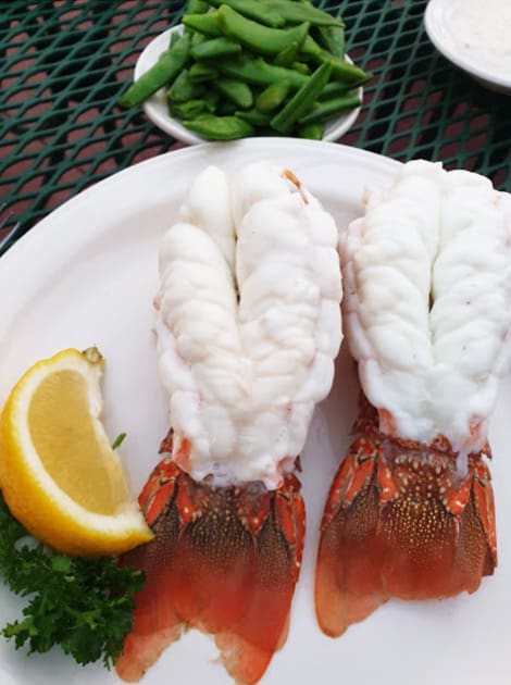 two lobster tails on a white plate