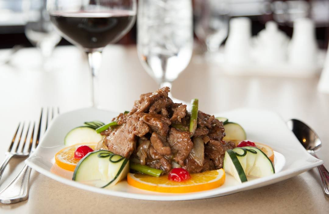 a plate of asian beef and vegetables
