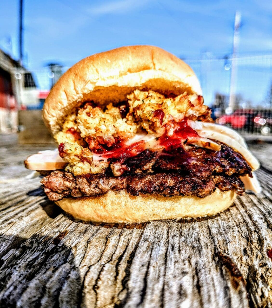a smash burger sitting on wooden table