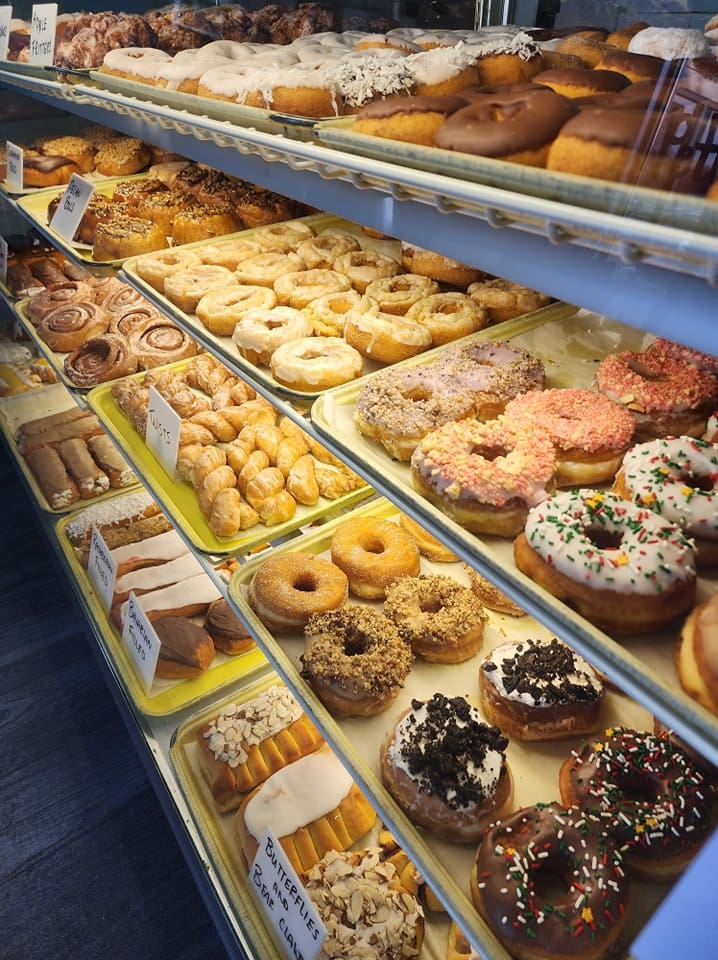a glass case full of donuts