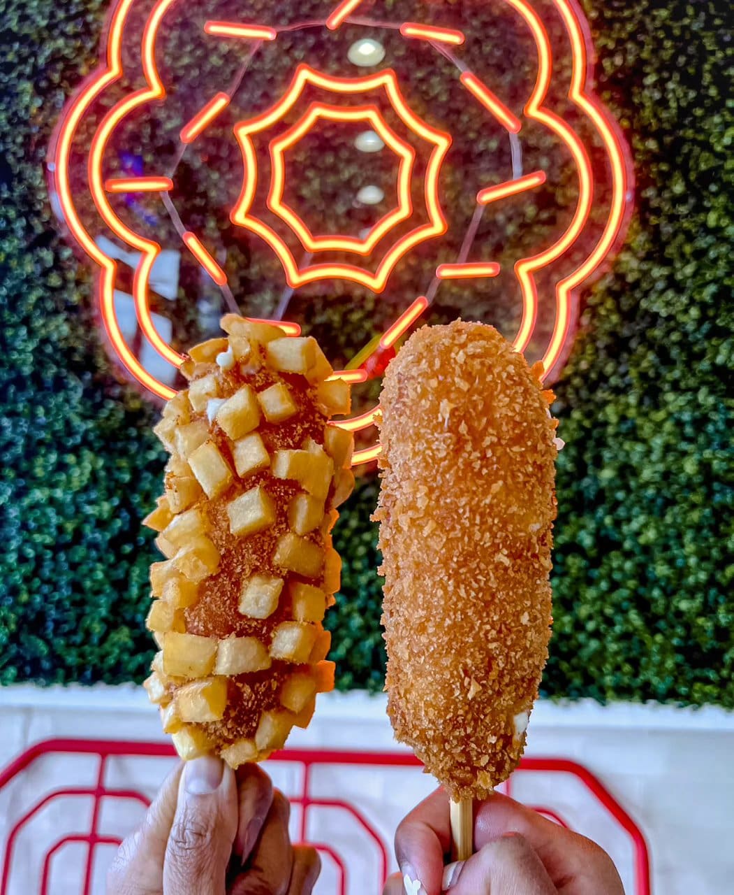 Two delicious Mochinut rice hot dogs on display, symbolizing the fusion of American and Japanese cultures.