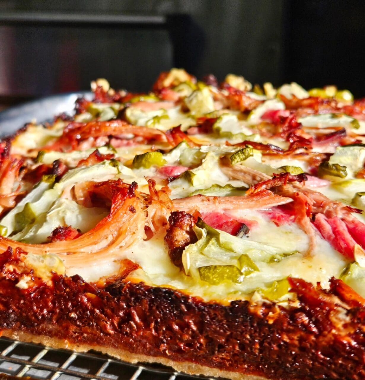 a Detroit Style Pizza on a wire rack
