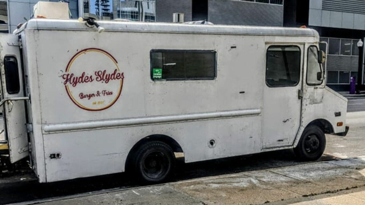 a white food truck that sells burgers