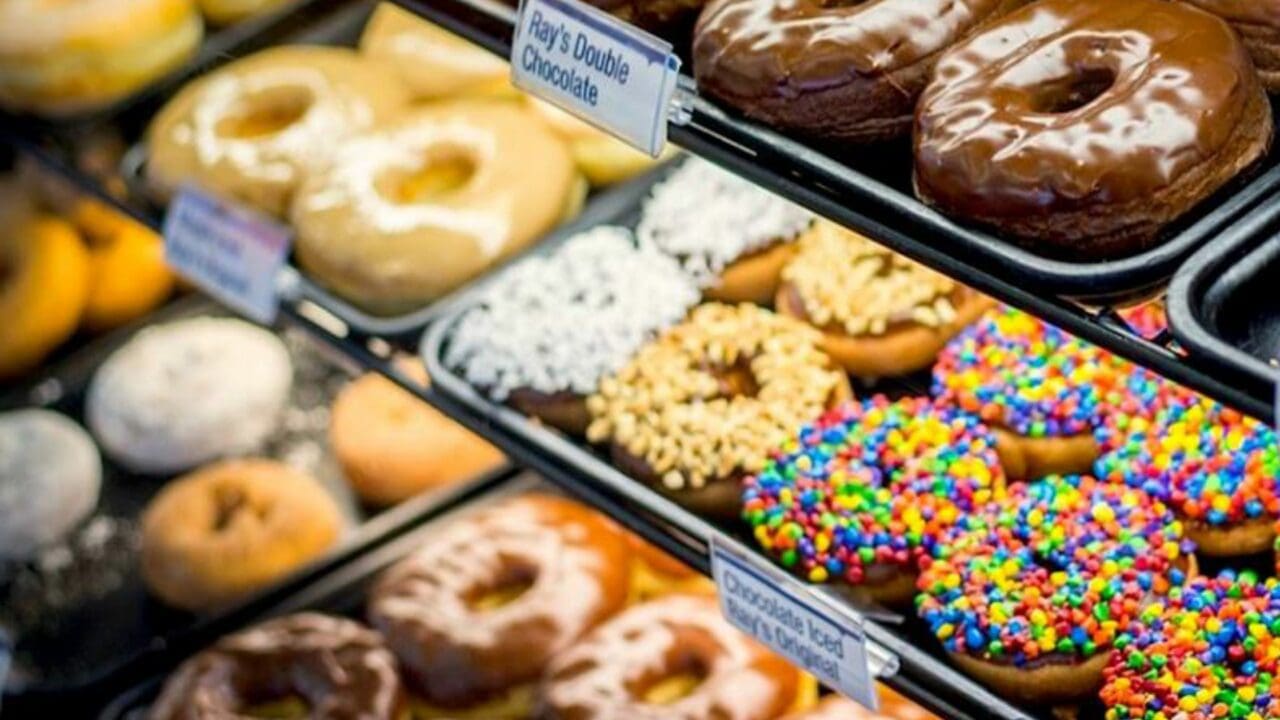 a glass case full of circular donuts