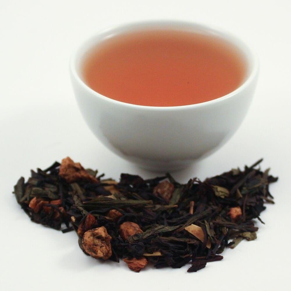 cup of tea and loose tea leaves on a white background
