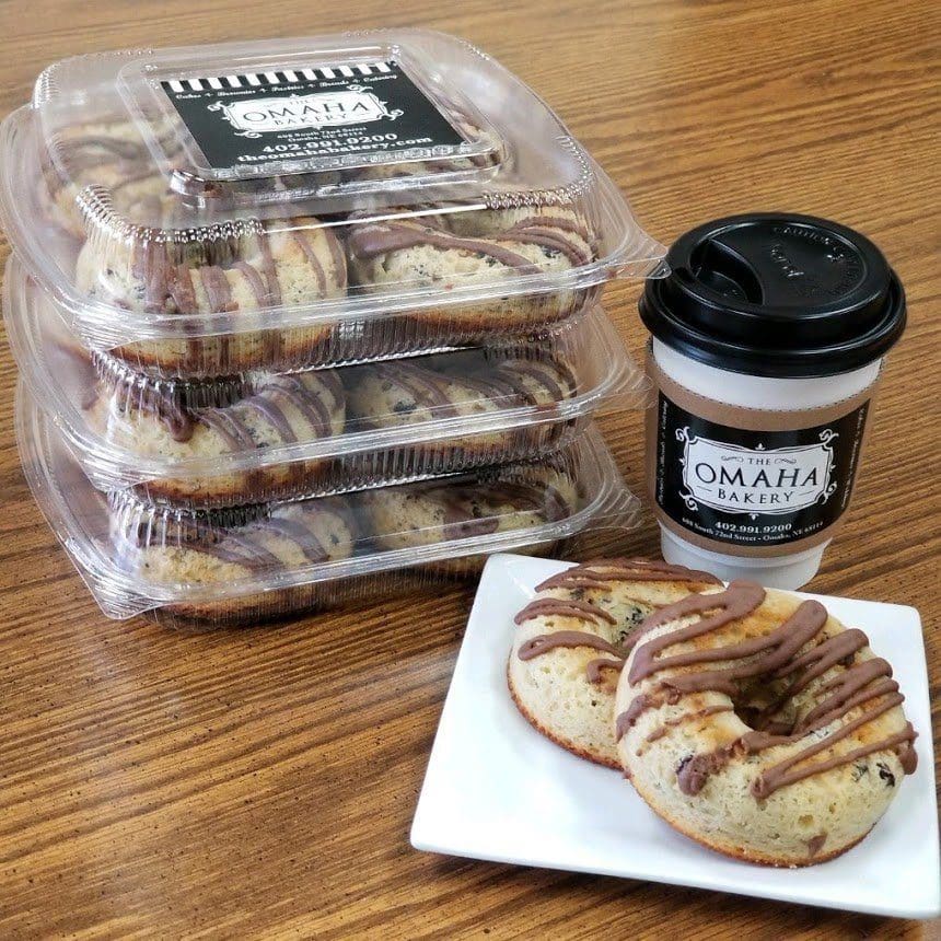 boxes of keto donuts next to coffee and a plate of keto donuts from the omaha bakery